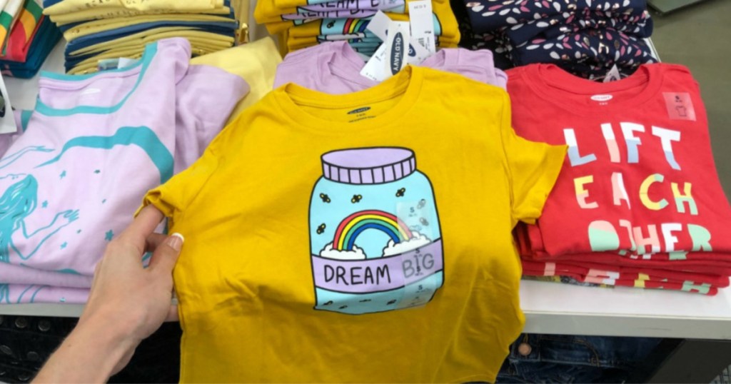 hand holding dream big shirt in store