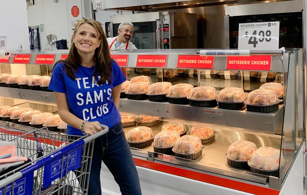 woman by rotisserie chickens at Sam's Club