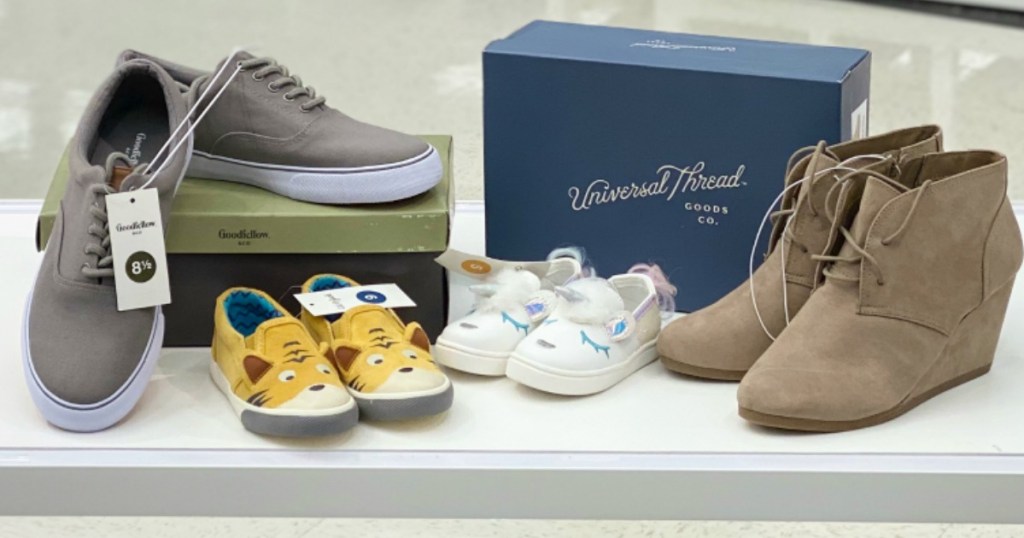four pairs of shoes sitting on table