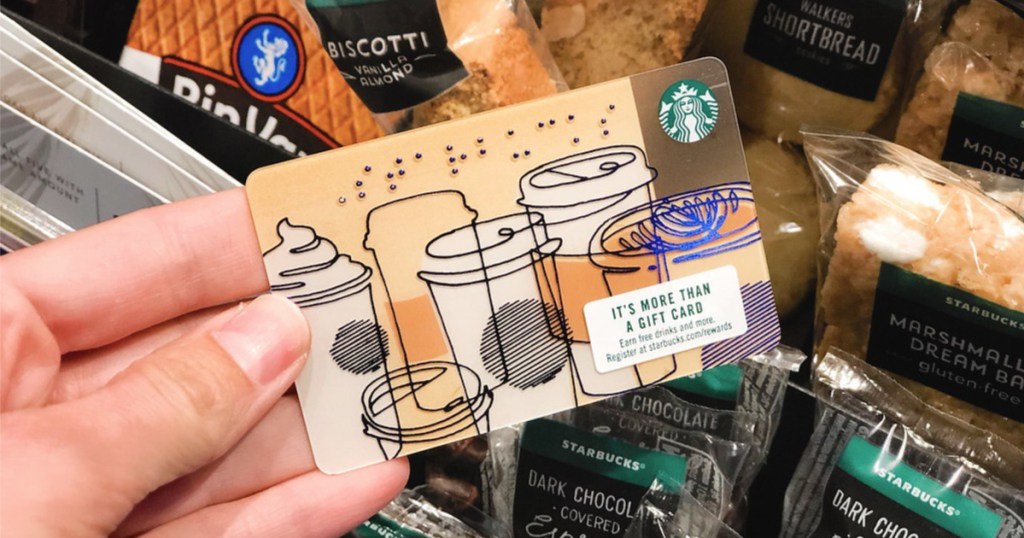 woman hand holding starbucks gift card with coffee images on the card