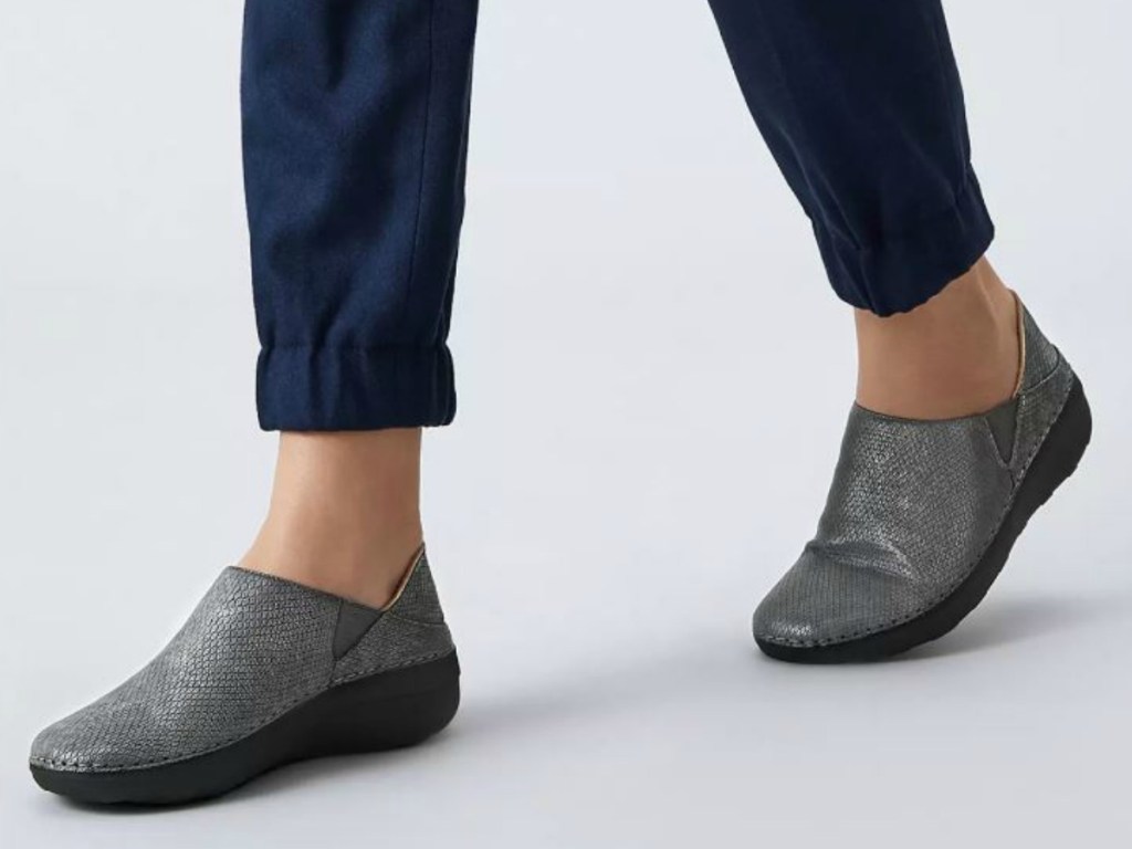 legs with pants and grey shoes