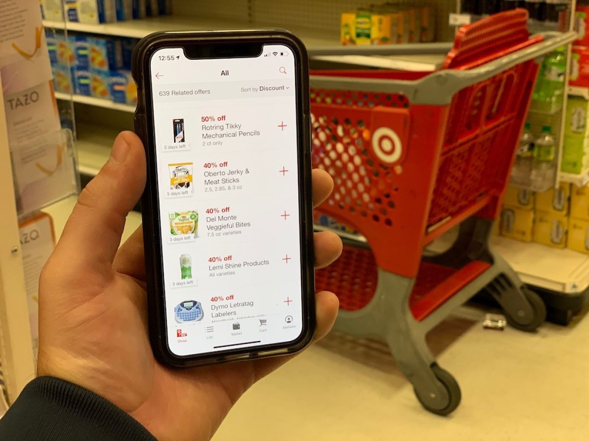 holding iPhone with Target circle household offers
