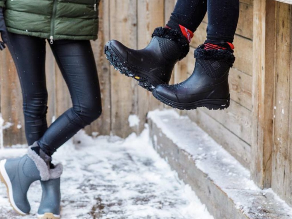 legs showing black and blue the original muck boots with snow on the ground