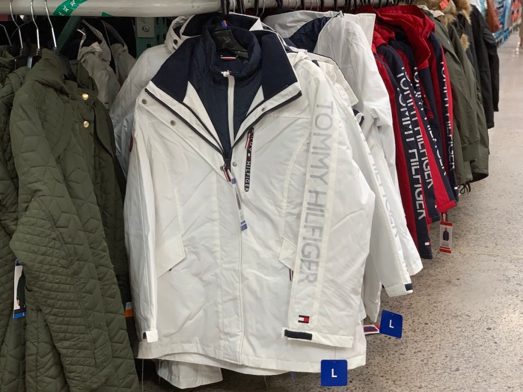 row of tommy hilfiger winter coats hanging on rack