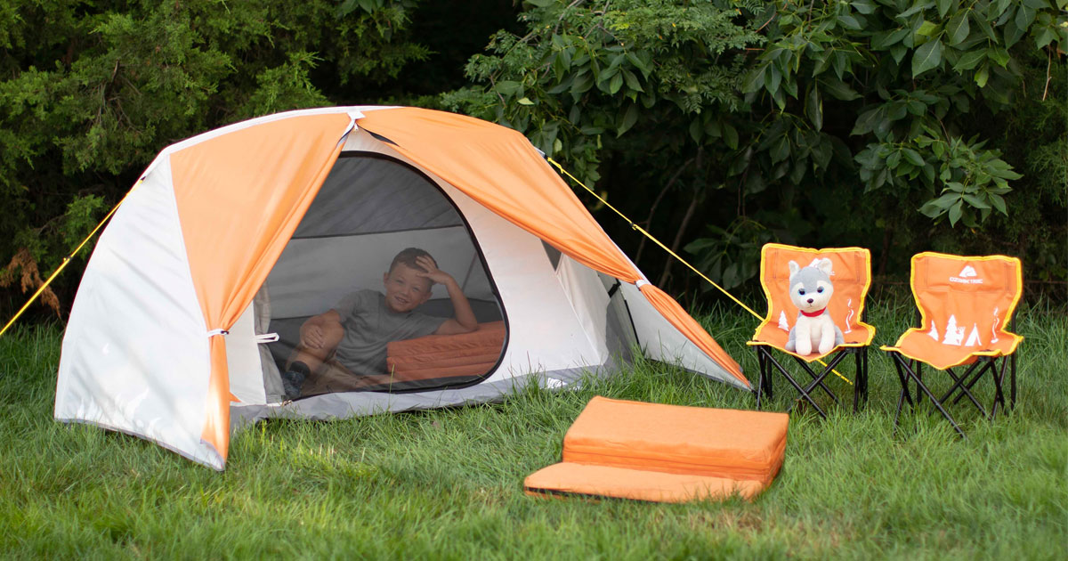 child laying in ozark trail kids tent with matching chairs