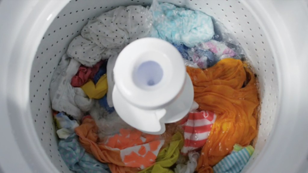 colorful clothes in washing machine agitator