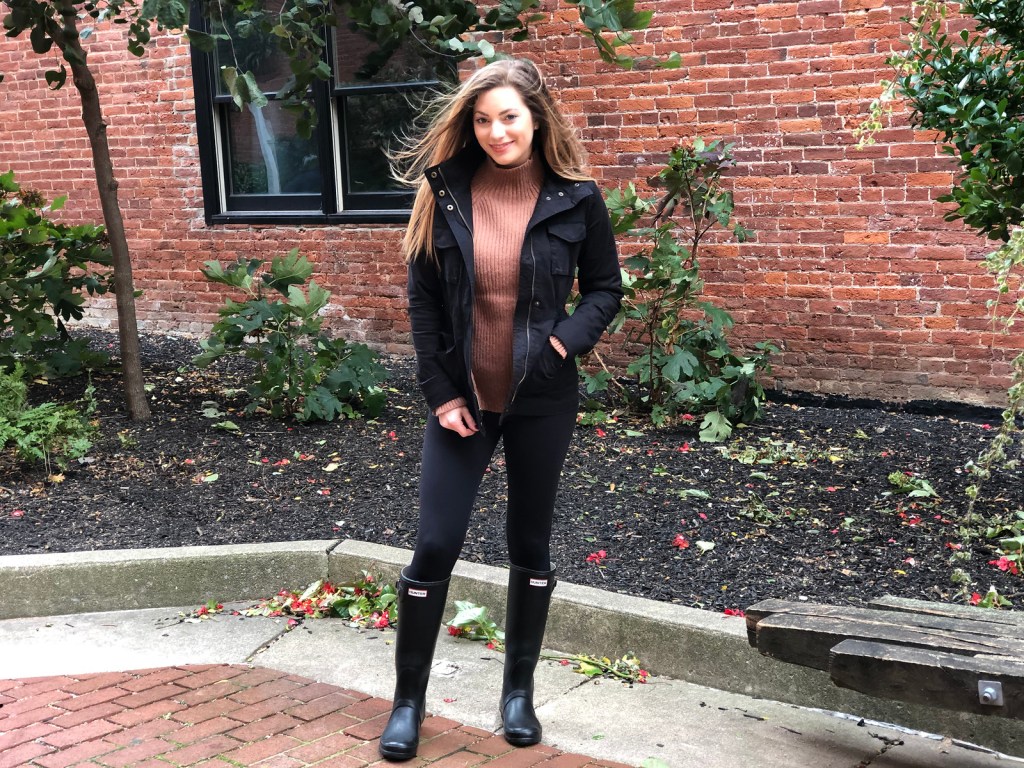 woman wearing military style cargo jacket and Hunter boots 