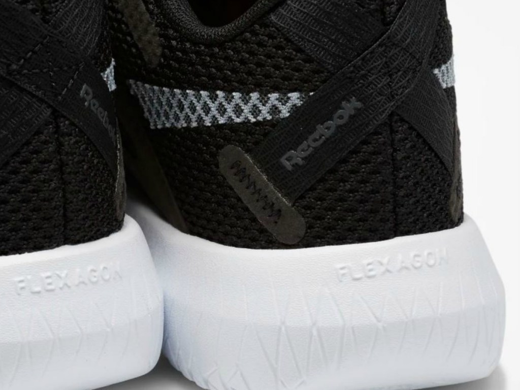 back of black pair of Reebok shoes
