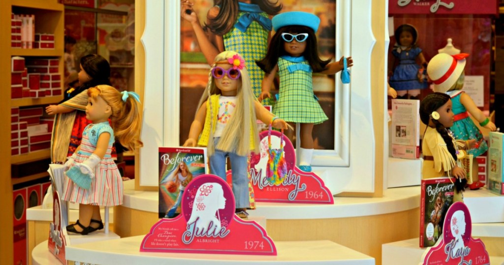 American Girl mini dolls with books on display