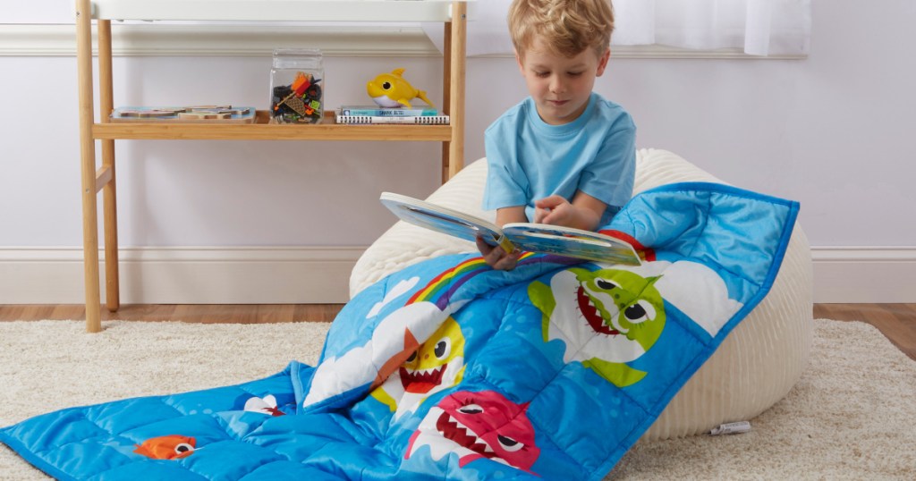 kid reading and using baby shark weighted blanket