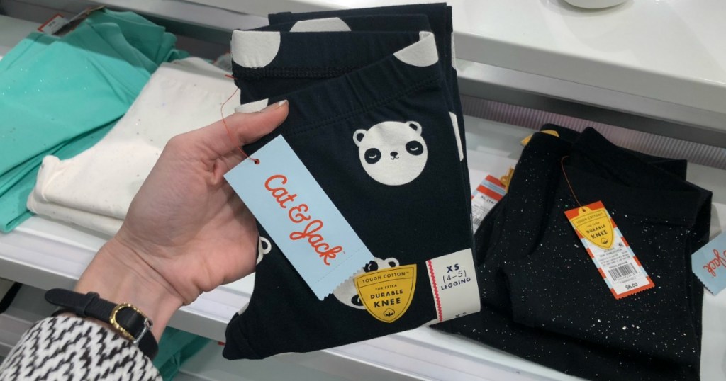 Woman holding pair of Cat & Jack Animal Leggings