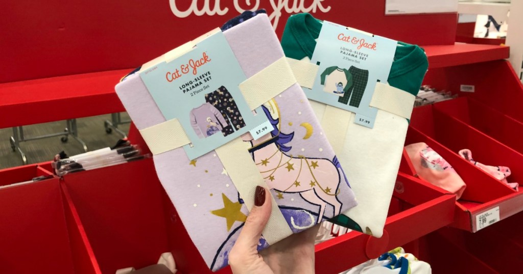 Woman holding Cat & Jack Pajama Sets in Target