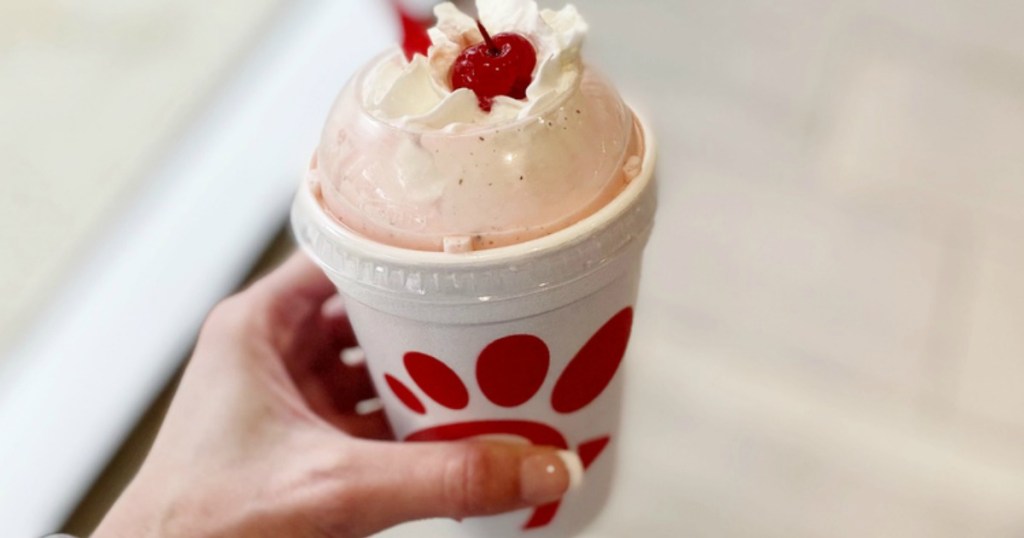 lady holding a Chic fil a Peppermint shake