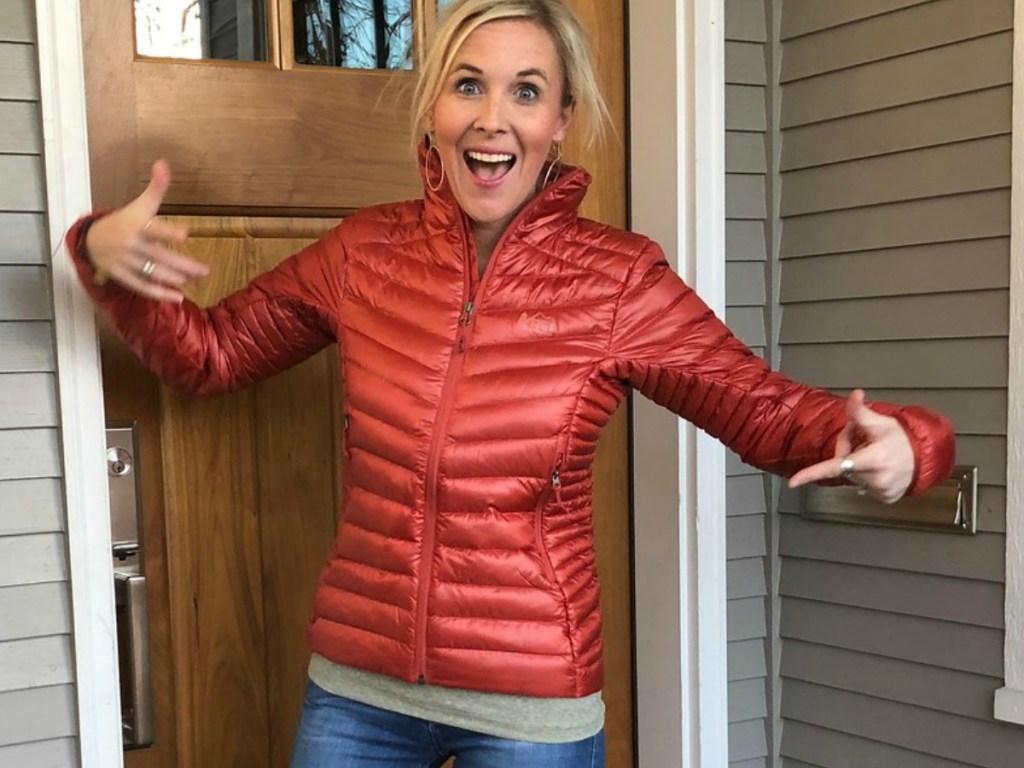 Woman wearing an REI Co-op Jacket in a doorway