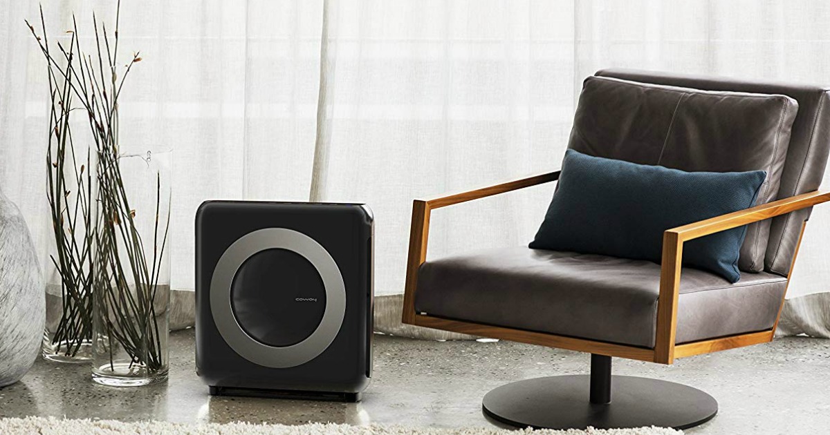 black air purifier next to armchair