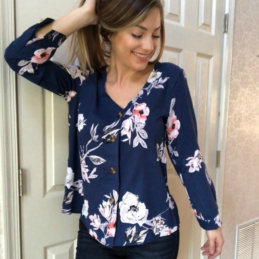 girl wearing a navy blue and floral shirt