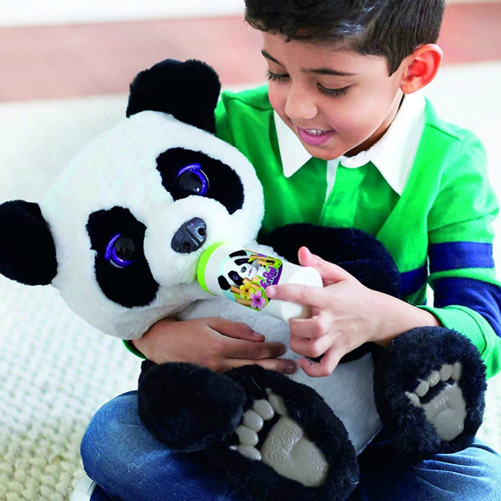 Boy holding interactive plush panda bear