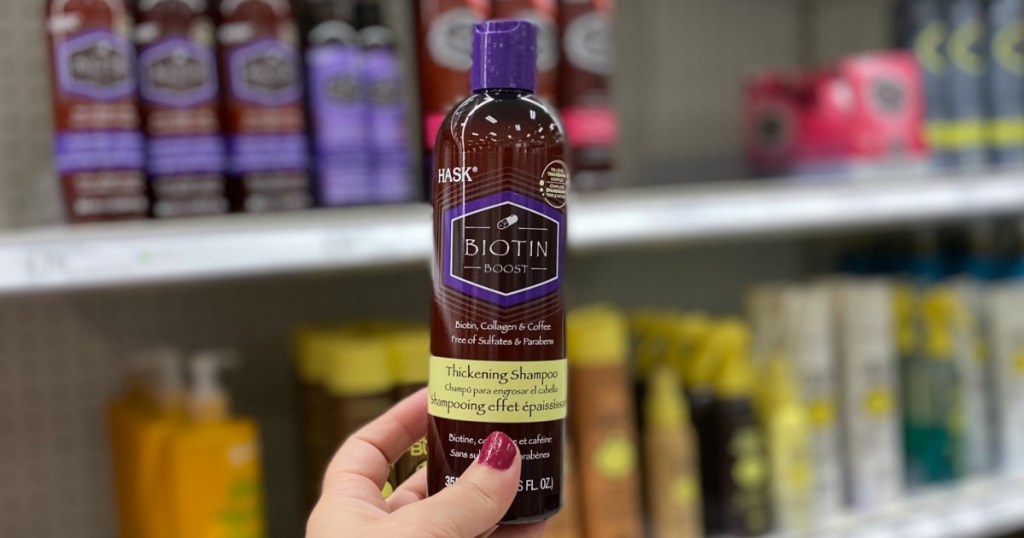 Hand holding Hask Biotin Shampoo