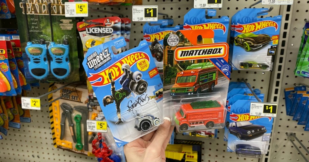 hand holding Hot Wheels Cars