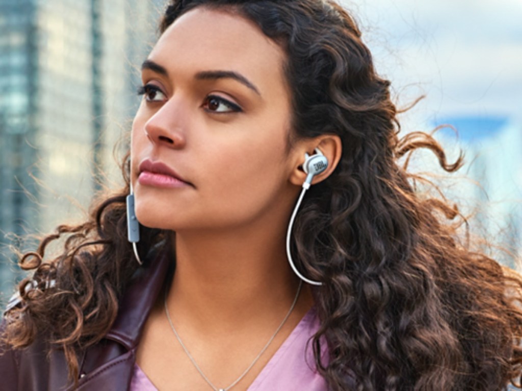 Woman in the city wearing JBL Earbuds 