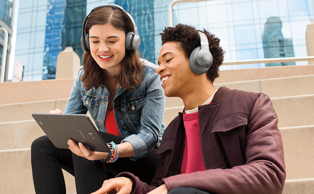 man and woman wearing JBL Headphones