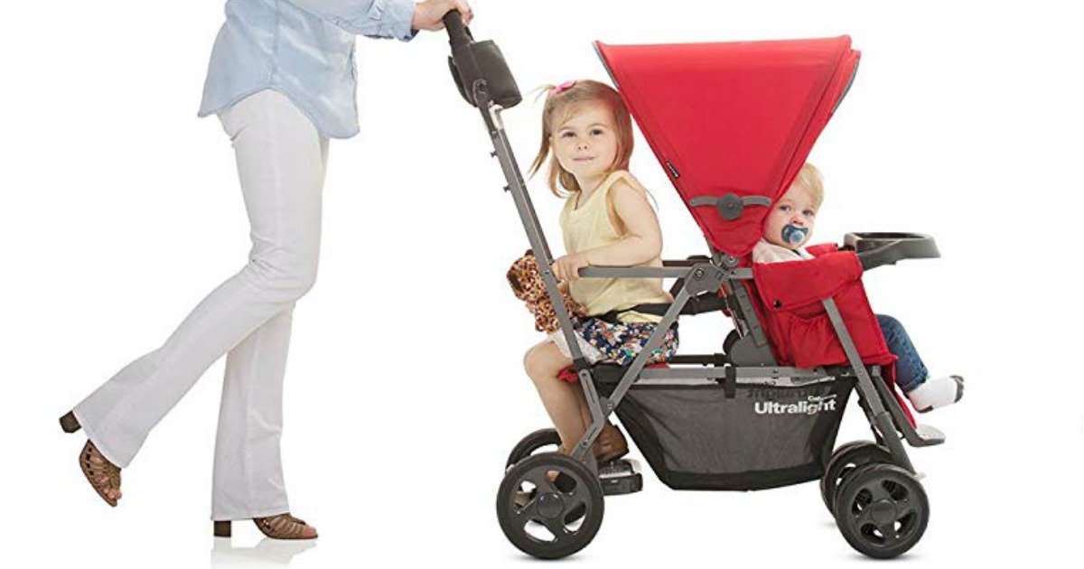 woman pushing red stroller with kids