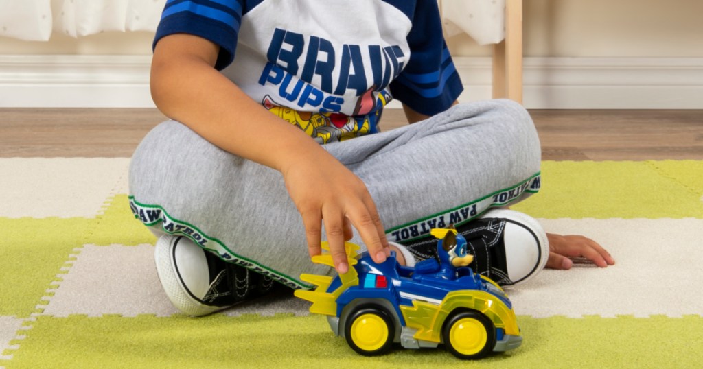 boy playing with paw patrol chase deluxe vehicle toy