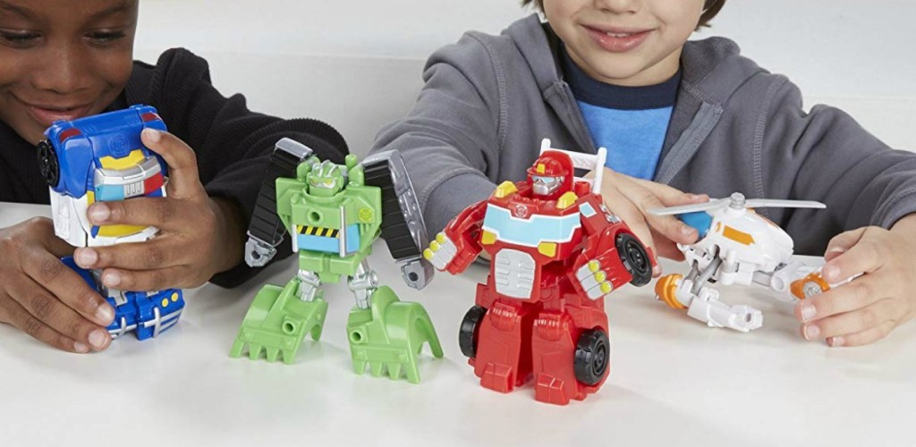 Two boys playing with Playskool Transformers Set