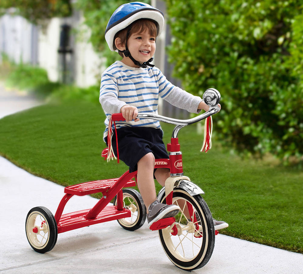 boy riding tricycle