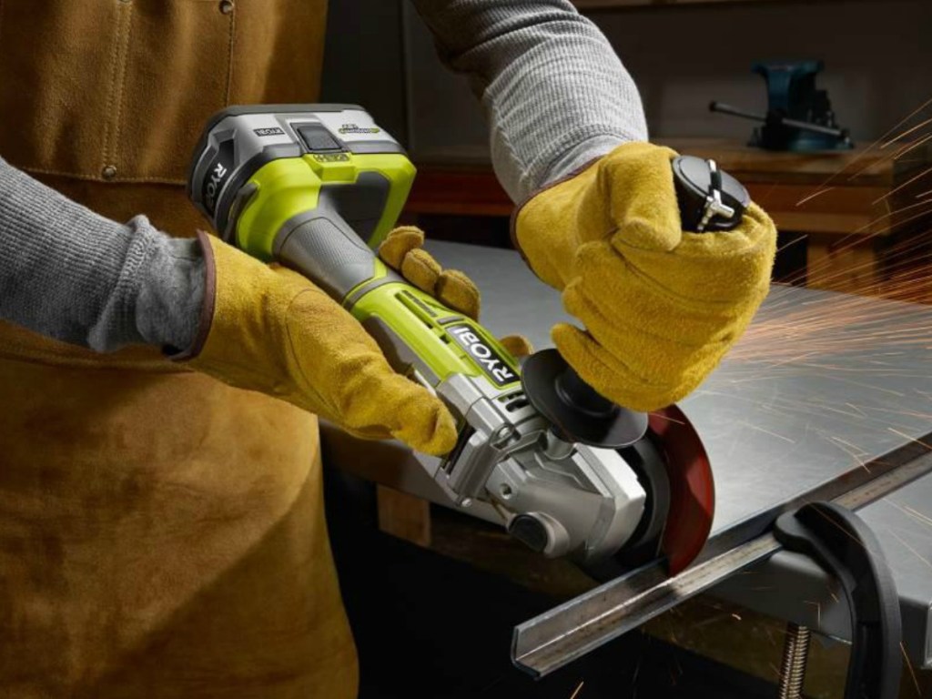 Man wearing work gloves and using Ryobi Angle Cutter