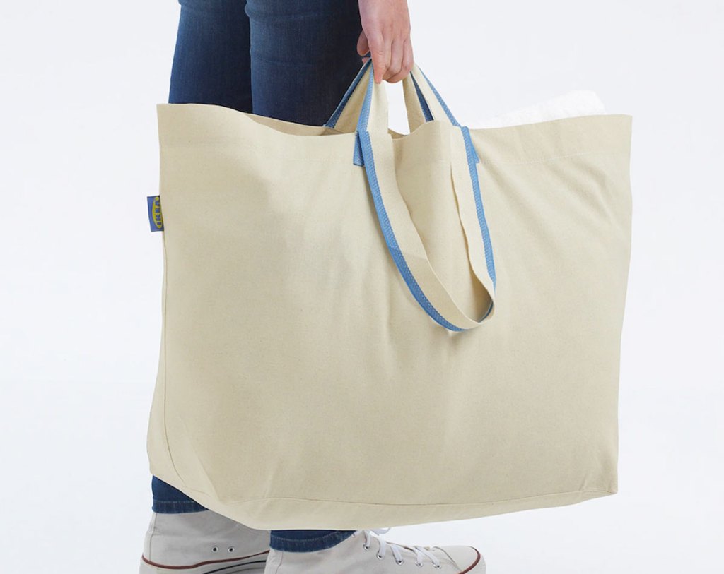 holding large tote bag