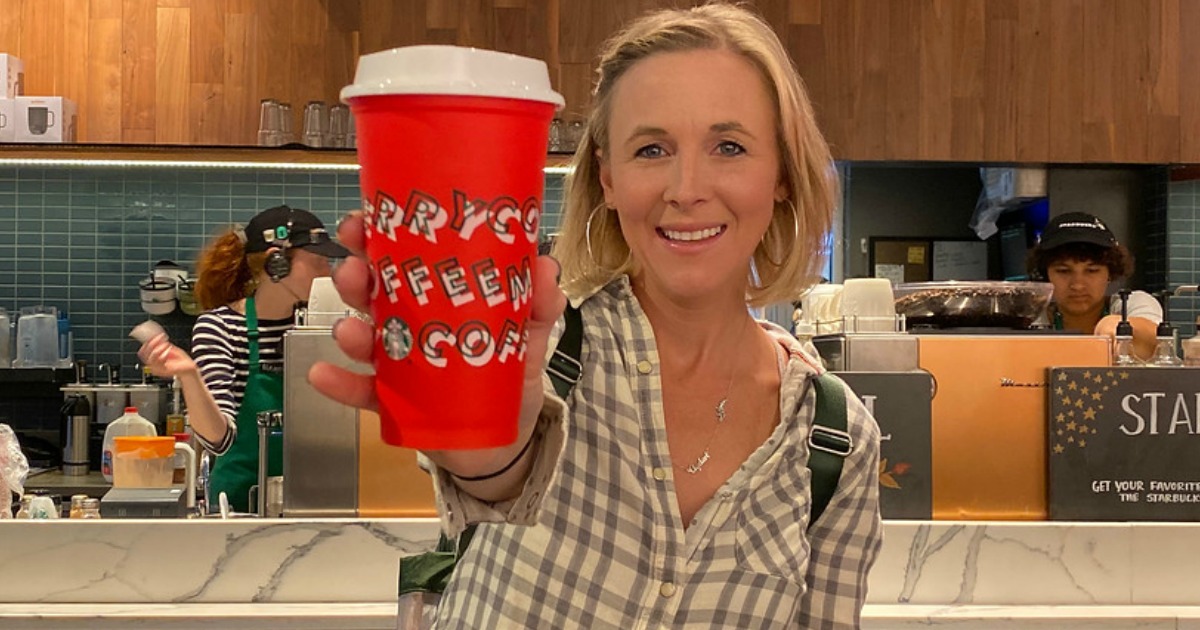 woman holding a Starbucks Free cup