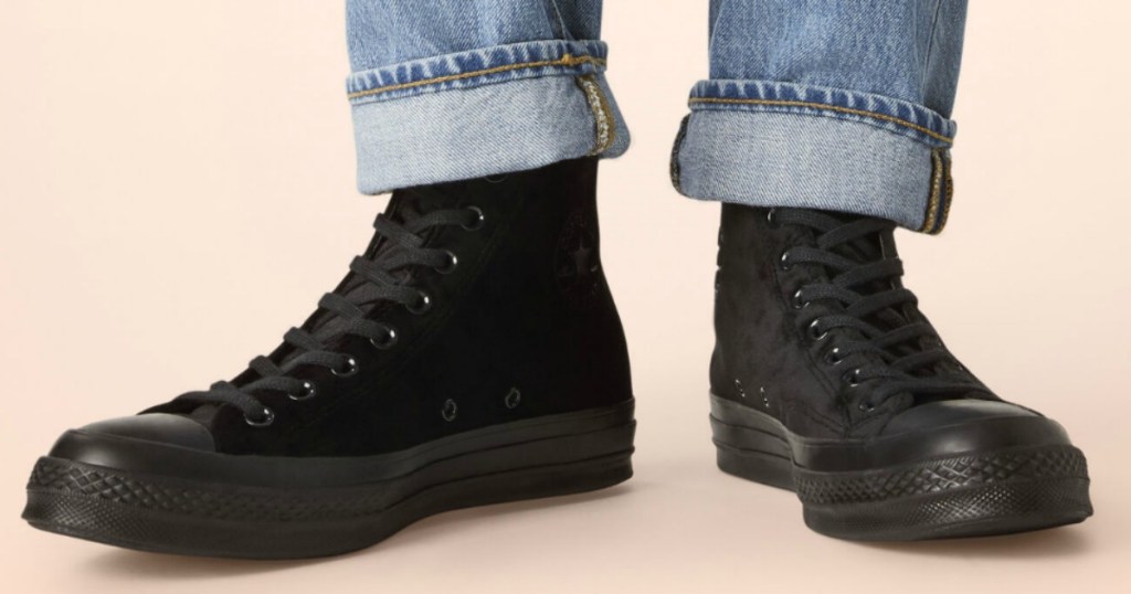 Woman wearing black velvet high tops