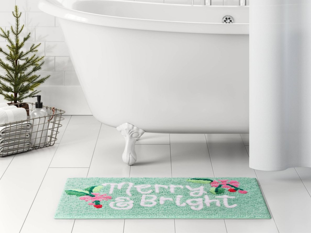 merry & bright bath rug in front of white tub