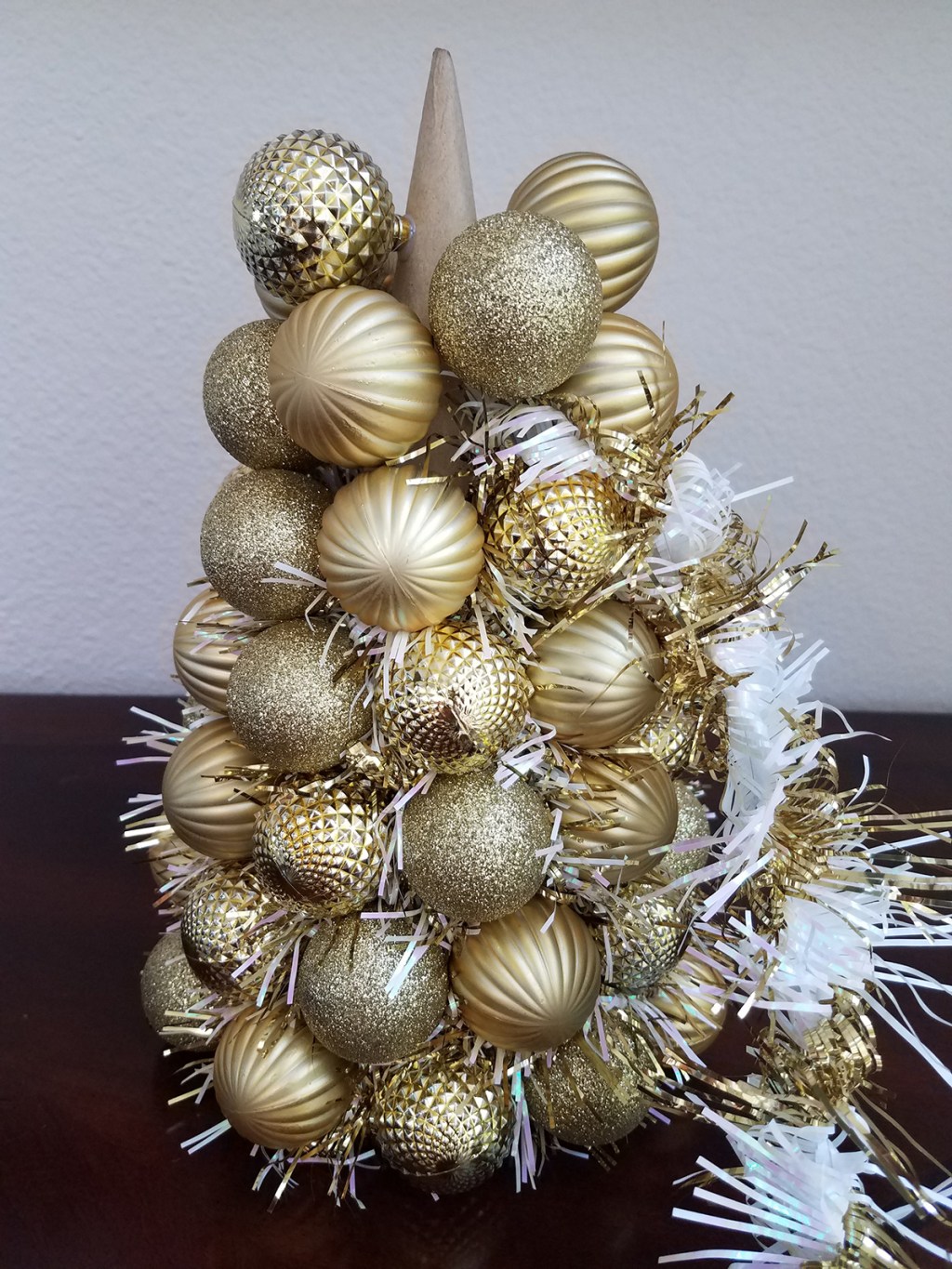 Adding white and gold garland to gold ornament centerpiece