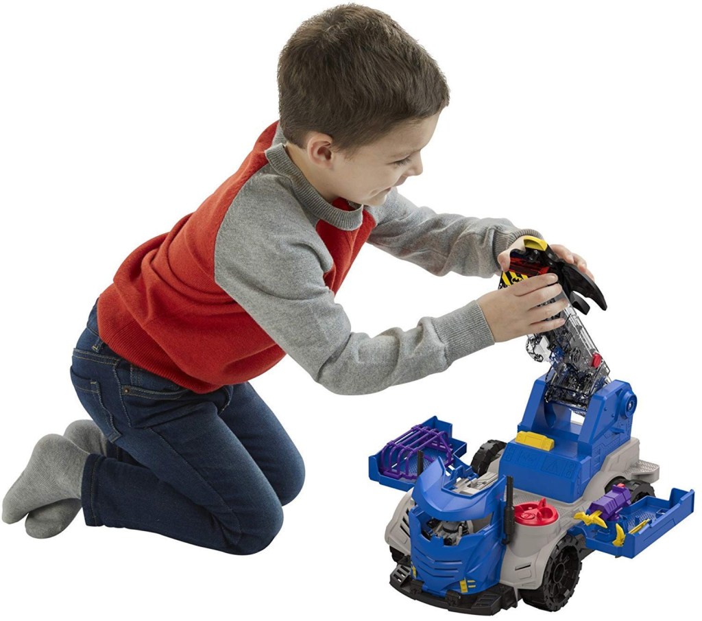 boy playing with Imaginext DC Super Friends, R/C Mobile Command Center