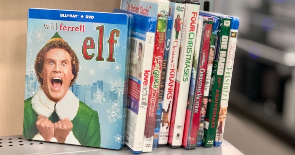 elf and other christmas movies stacking in a row on store shelf