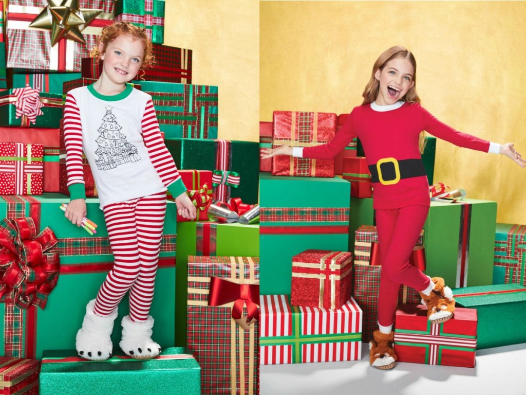 girls by presents wearing pajamas