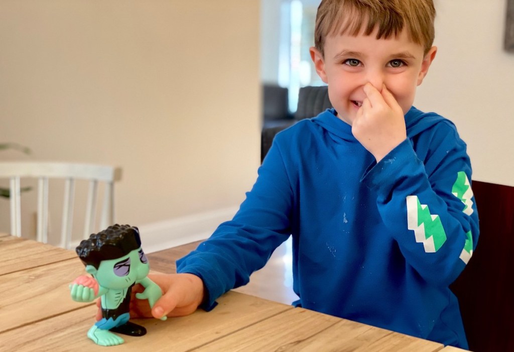 boy holding his nose and farting butthead toy 