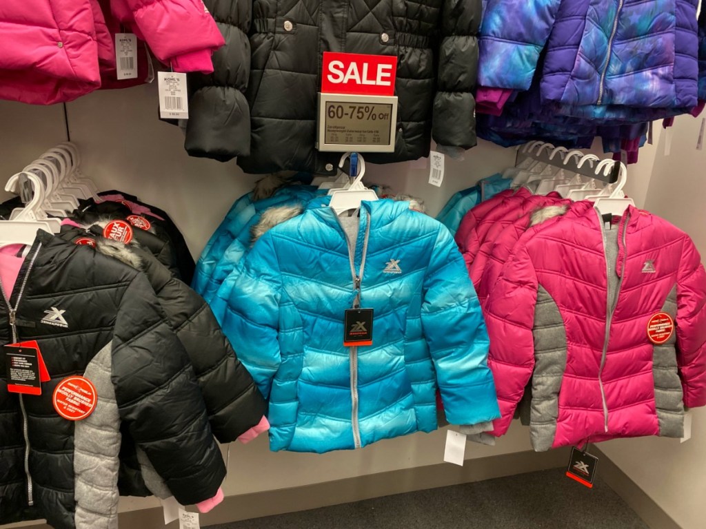 jackets in different colors hangning in store