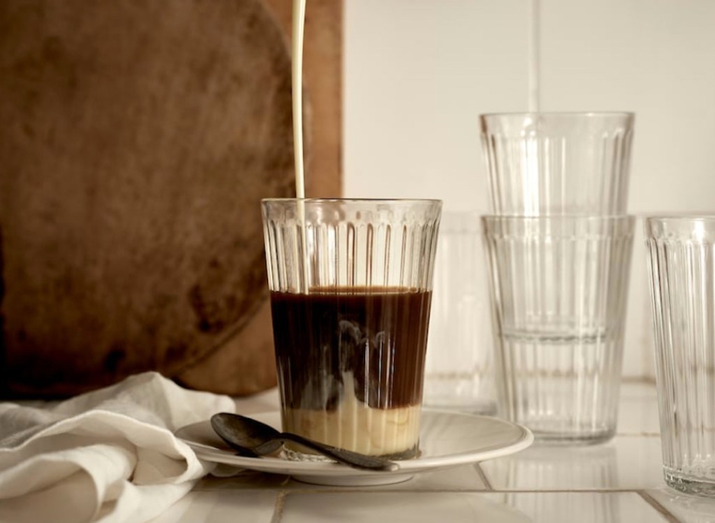 iced coffee on white plate sitting next to empty drinking glasses