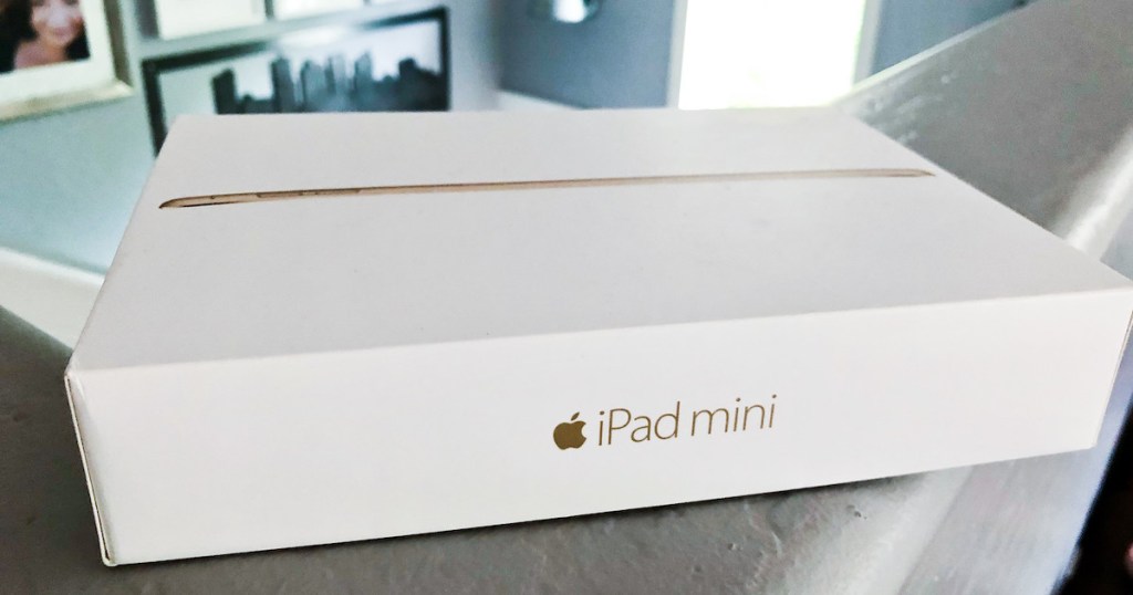 white ipad mini box sitting on railing