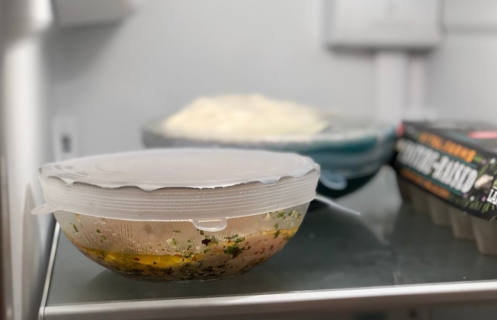 clear glass bowl with food and silicone lids on top