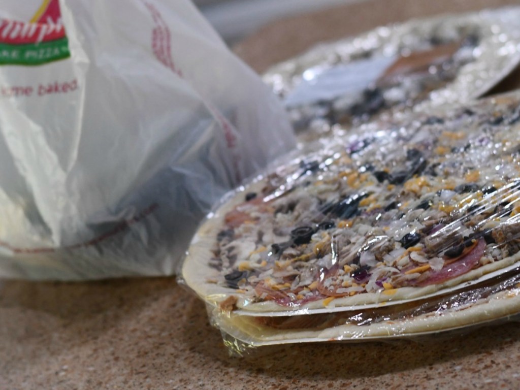 pizza on table with bag