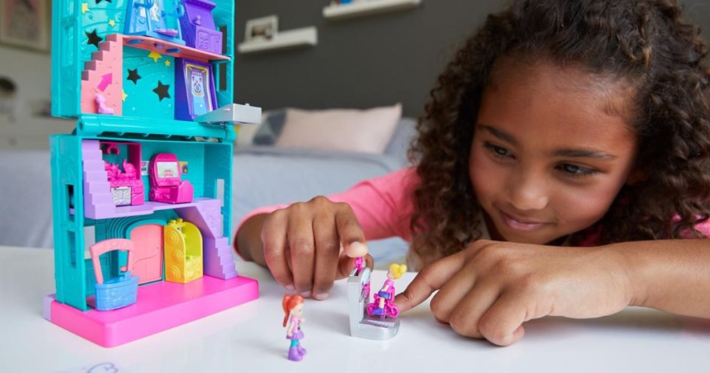 girl playing with Polly Pocket toys