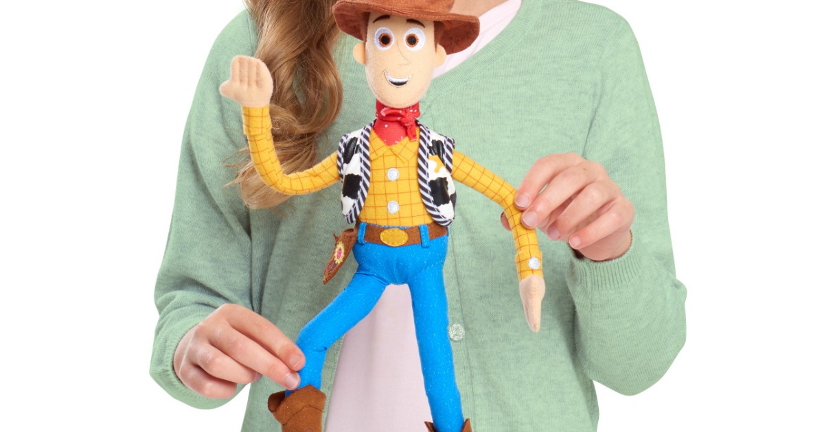 girl playing with Toy Story 4 Woody doll