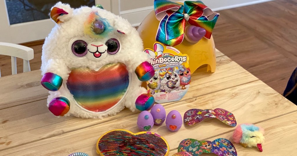 fluffy rainbow unicorn animal on table with other colorful toys 