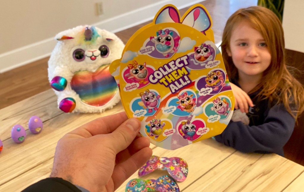hand holding a rainbocorns collect them all packet