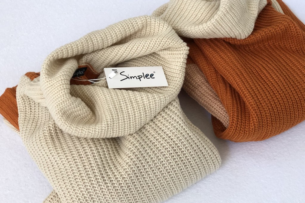 beige and orange sweaters folded 