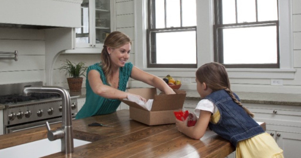 Mother and daughter packaging gift to ship via UPS